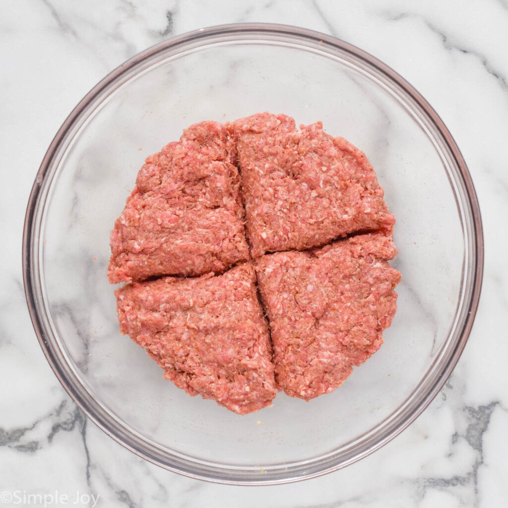 overhead of bowl of ground hamburger and seasonings to make hamburgers