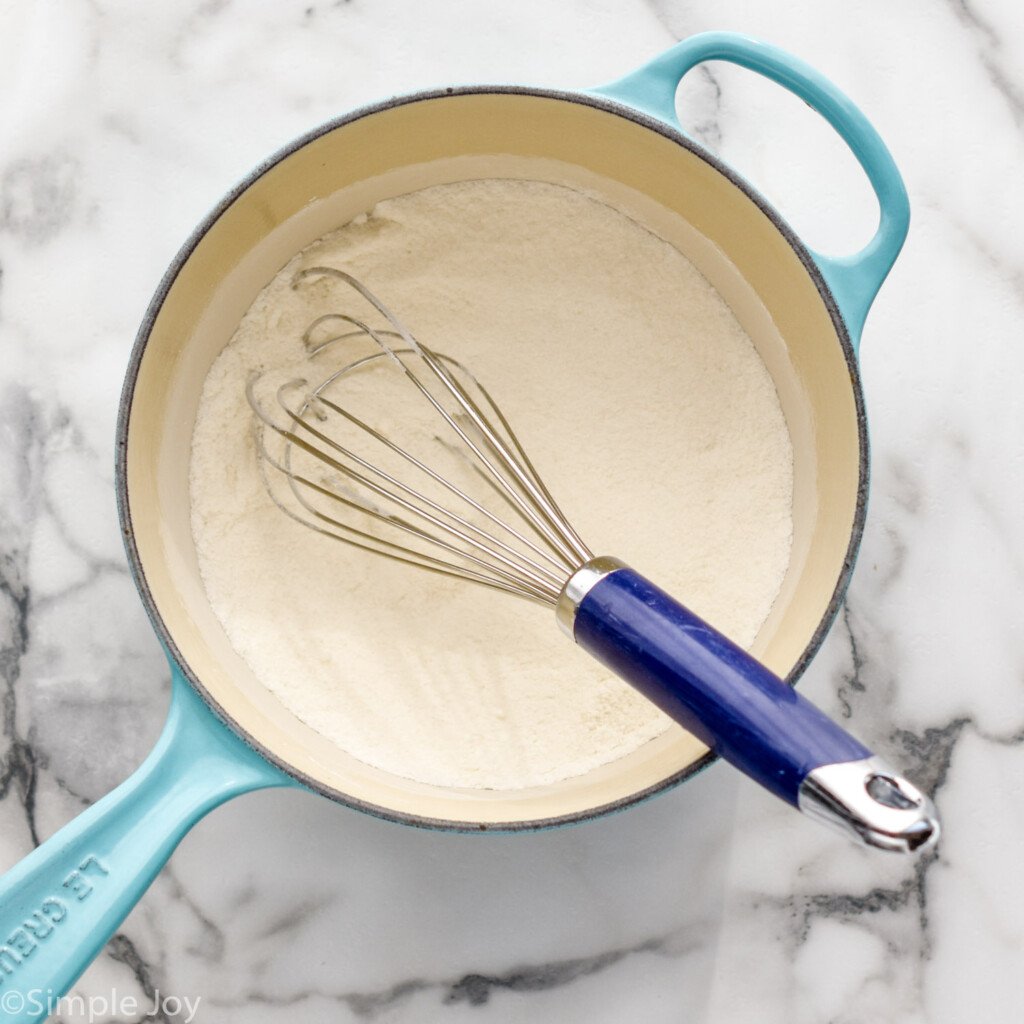 overhead of saucepan of Lemon Meringue Pie filling ingredients with whisk