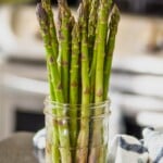 fresh asparagus in a mason jar with water