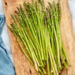 overhead of fresh asparagus on a cutting board