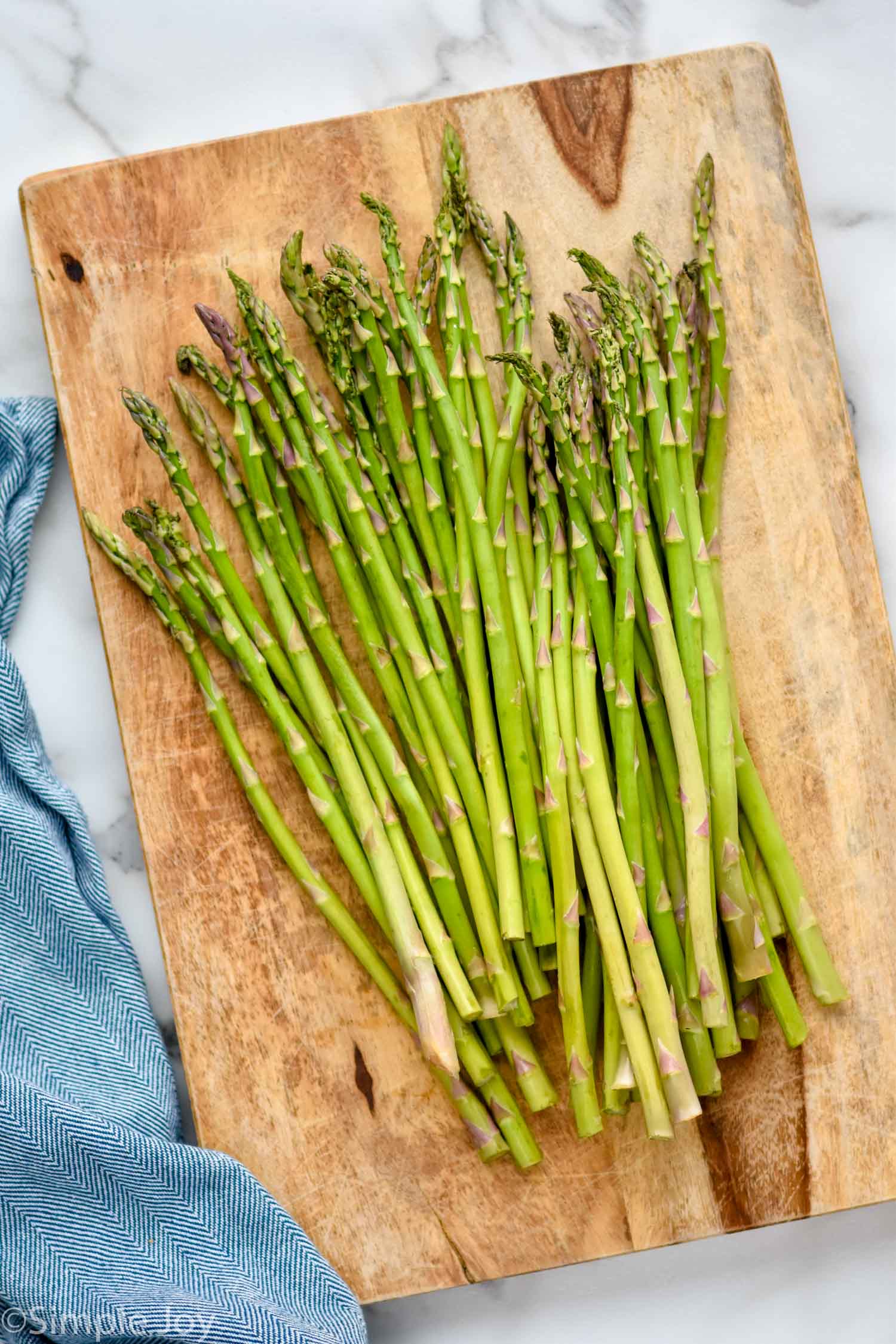overhead of fresh asparagus on a cutting board