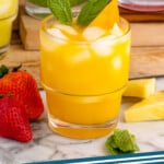 Pinterest graphic for Agua Fresca recipe. Image shows Agua Fresca in four flavors served in glasses over ice with fruit and mint leaves as garnish. Fruit chunks and mint leaves beside for garnish. Text says, "agua fresca simplejoy.com."