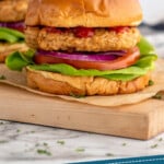 Pinterest graphic for Air Fryer Turkey Burgers recipe. Image shows side view of Air Fryer Turkey Burgers served on buns with lettuce, tomato, and onion. Text says, "Air Fryer Turkey Burgers simplejoy.com."