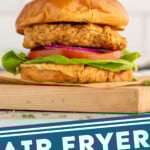 Pinterest graphic for Air Fryer Turkey Burgers recipe. Image is side view of Air Fryer Turkey Burger served on buns with lettuce, tomato, and onion. Text says, "Air Fryer Turkey Burgers simplejoy.com."