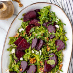 Pinterest graphic for Beet Salad recipe. Text says, "the best Beet Salad recipe simplejoy.com." Image is overhead view of a platter of Beet Salad garnished with walnuts and goat cheese.