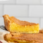Pinterest graphic for Chess Pie recipe. Text says, "the best Chess Pie recipe simplejoy.com." Image shows a slice of Chess Pie being served from Chess Pie.