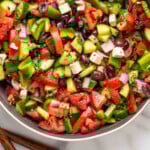 Pinterest graphic for Greek Salad recipe. Image is overhead view of a bowl of Greek Salad. Text says, "super easy Greek Salad simplejoy.com."
