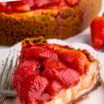 Pinterest graphic for Strawberry Cheesecake recipe. Text says, "the best Strawberry Cheesecake simplejoy.com" Image shows a slice of Strawberry Cheesecake on a plate with a fork.