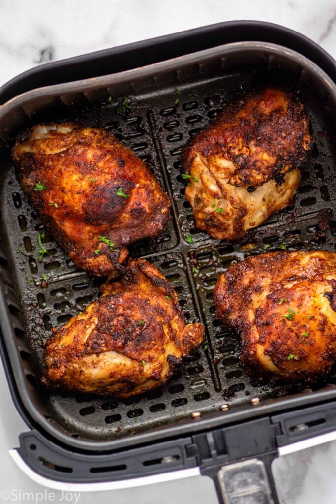 Overhead view of Air Fryer Chicken Thighs in air fryer basket.