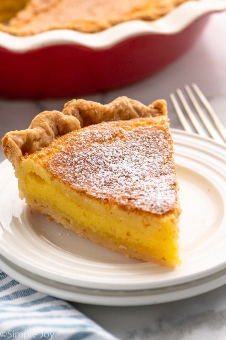 Slice of Chess Pie on a plate with a fork beside.