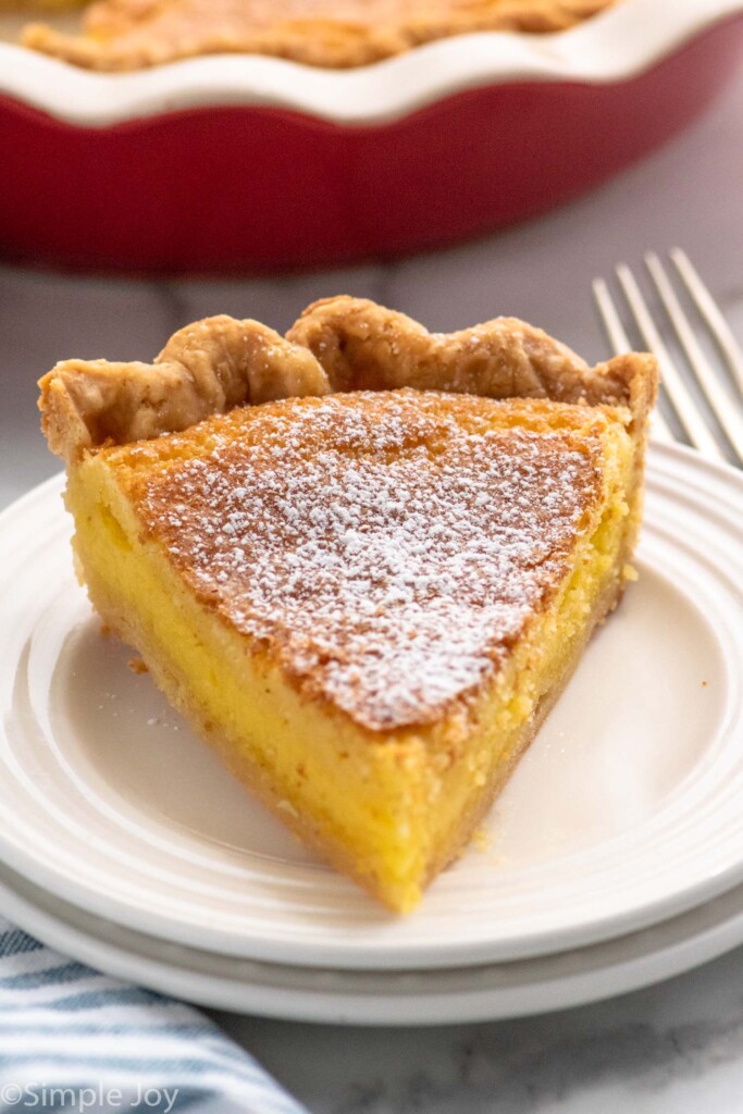 Slice of Chess Pie served on a plate with a fork beside.