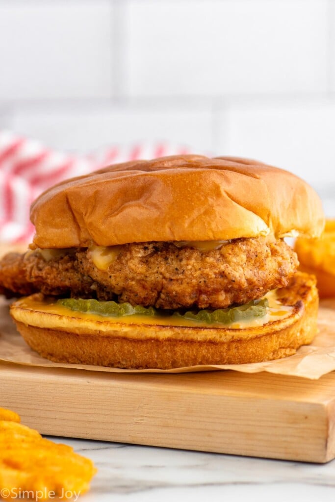 Side view of Chicken Sandwich with pickles and chick fil a sauce on a bun