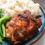 Air Fryer Chicken Thigh served on a plate with rice and green beans. - 11