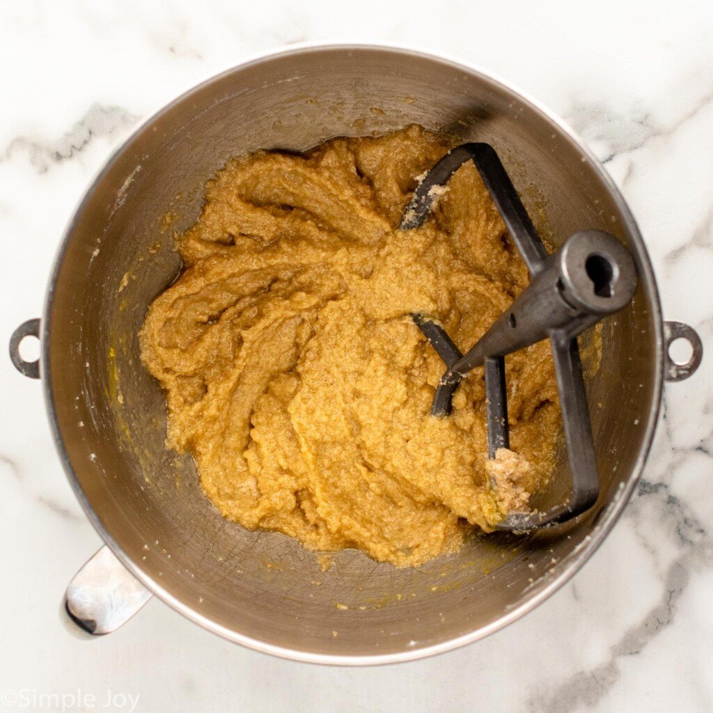 overhead of mixing bowl Chocolate Chip Cookie Bars ingredients and mixer attachment