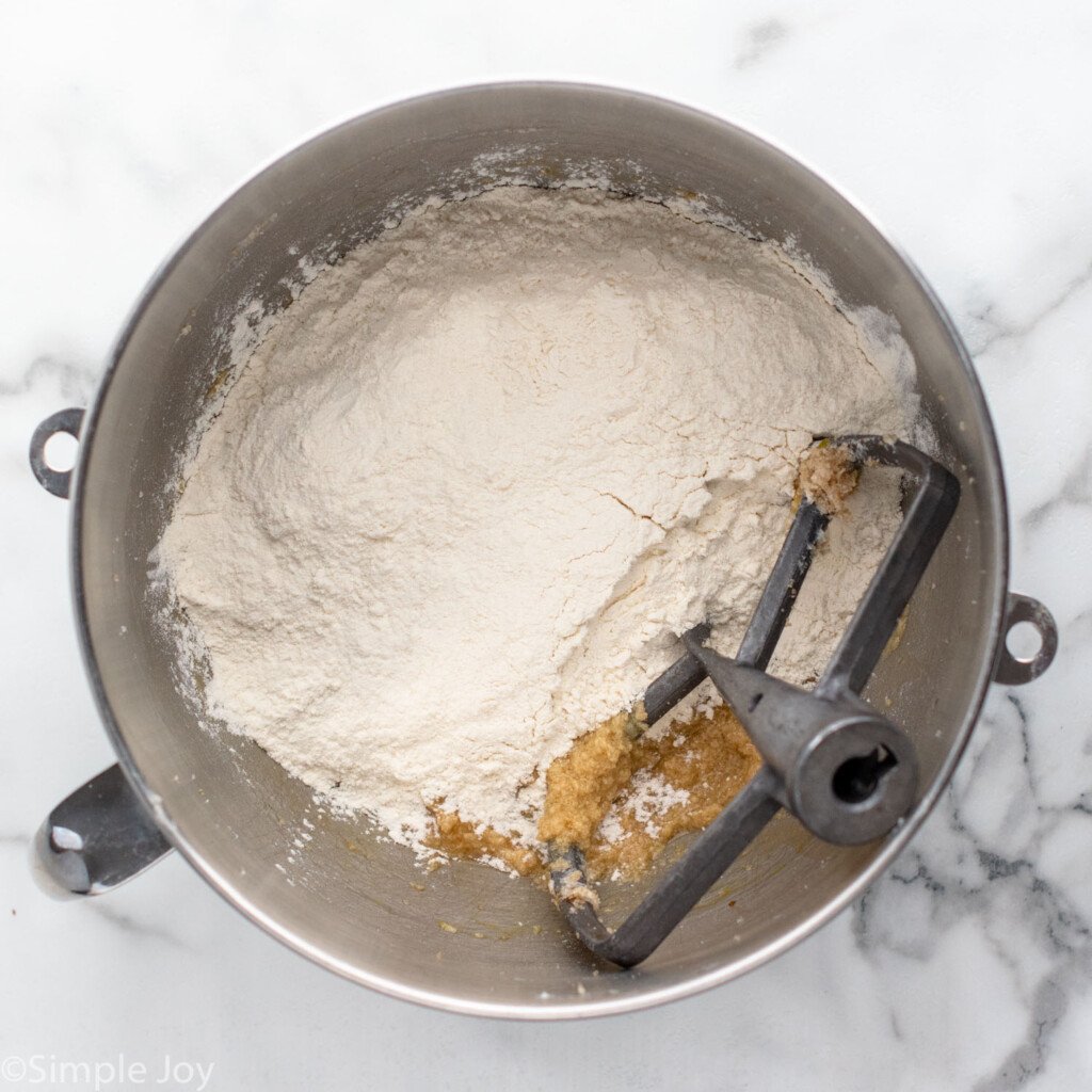 overhead of mixing bowl Chocolate Chip Cookie Bars ingredients and mixer attachment