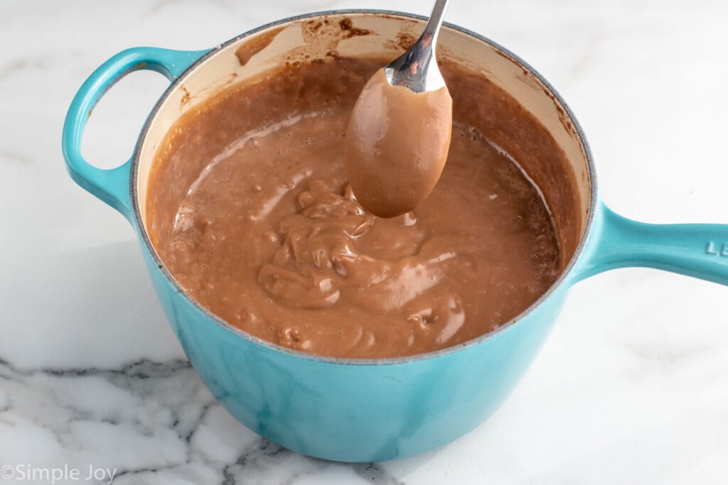 Saucepan of chocolate sauce with spoon for Chocolate Cream Pie recipe.