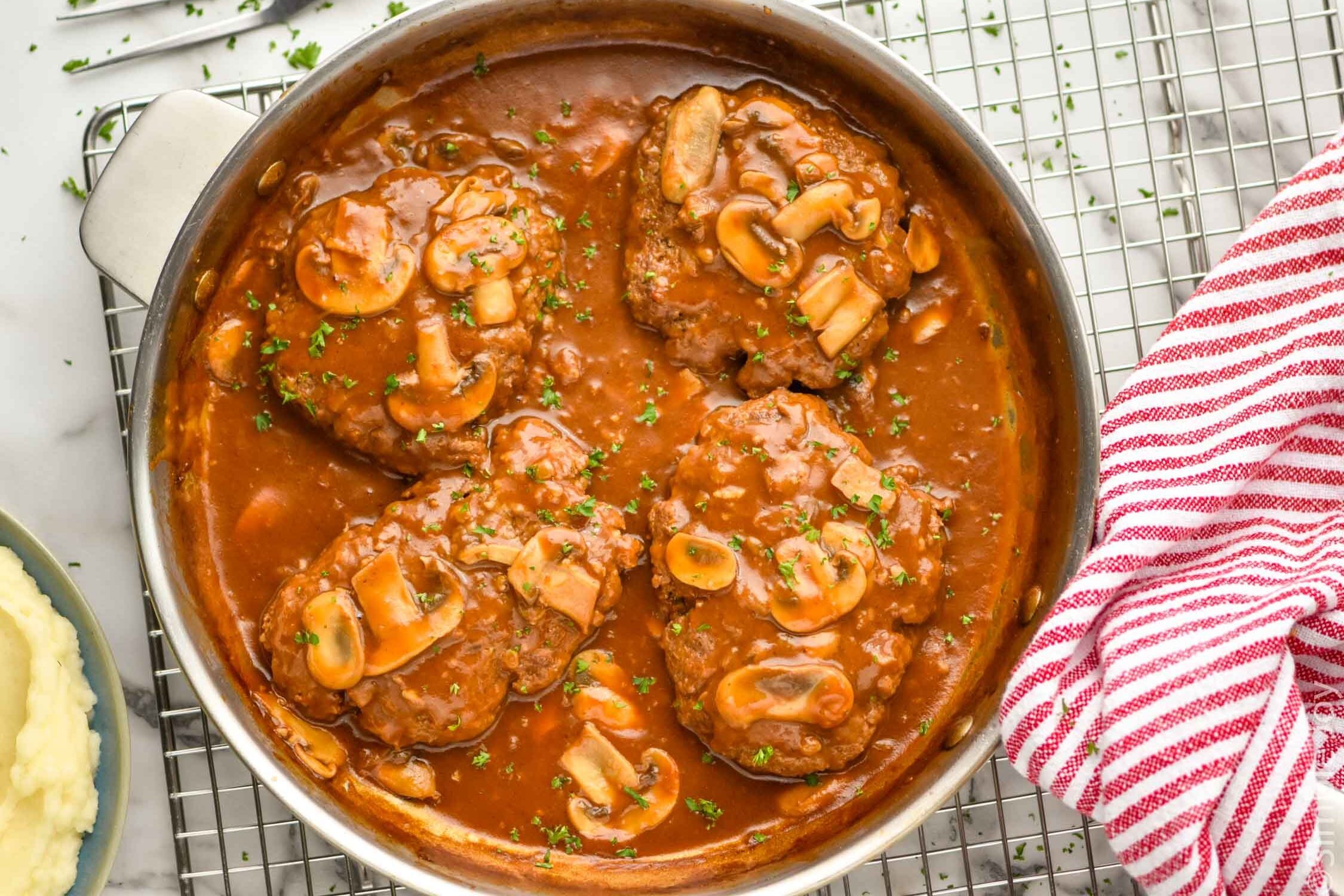 overhead of a skillet full of Salisbury steak