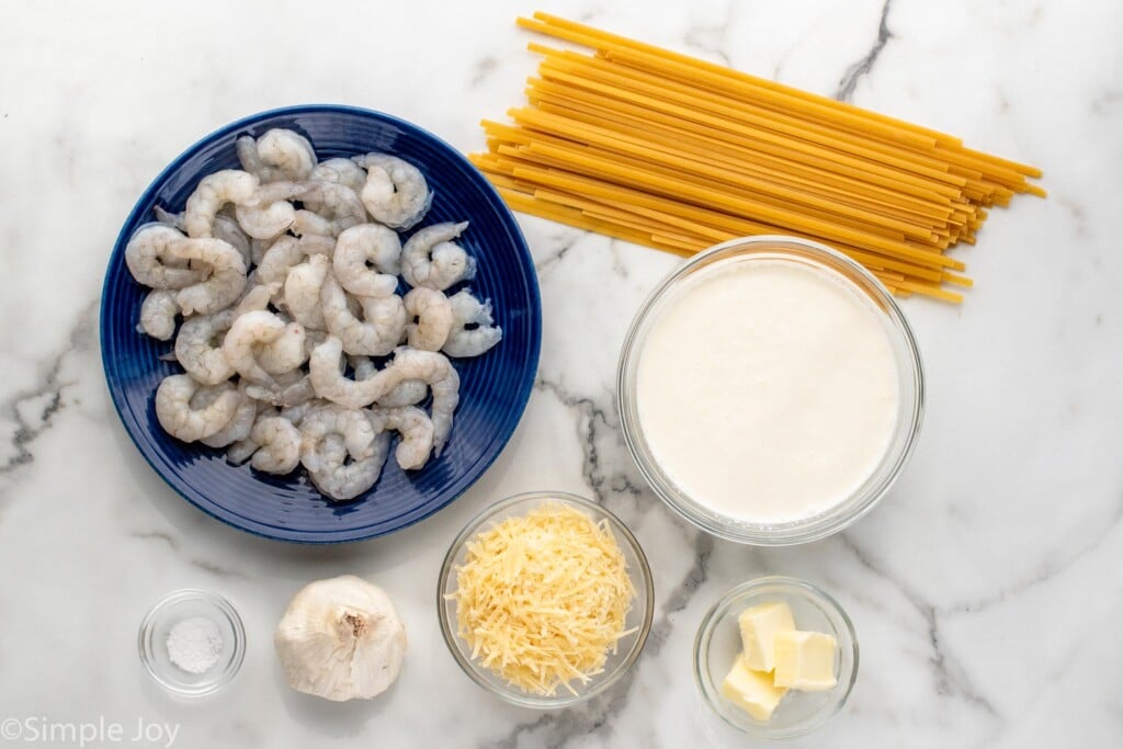 Overhead view of ingredients for Shrimp Alfredo recipe on countertop.