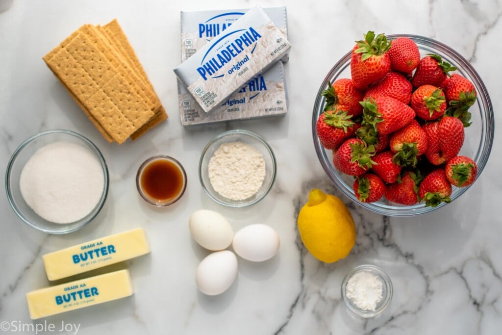 Overhead view of ingredients for Strawberry Cheesecake recipe on countertop