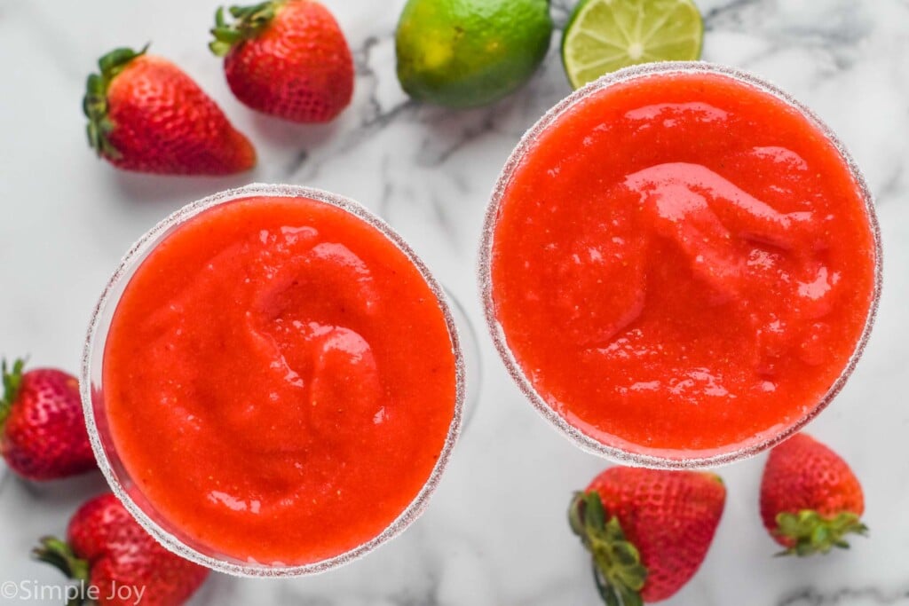 Overhead view of Strawberry Margaritas with limes and strawberries beside - 6