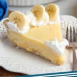 Pinterest graphic for Banana Cream Pie recipe. Image shows slice of Banana Cream Pie on a plate with a fork, garnished with whipped cream and banana slices. Text says, "Banana Cream Pie simplejoy.com."