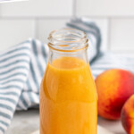 Pinterest graphic for Peach syrup recipe. Text says, "the best Peach syrup simplejoy.com." Image shows a jar of Peach syrup with peaches beside.