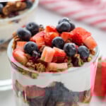 Pinterest graphic for yogurt parfait recipe. Text says, "the best yogurt parfait simplejoy.com." Image shows a yogurt parfait garnished with chopped strawberries, blueberries, and granola.