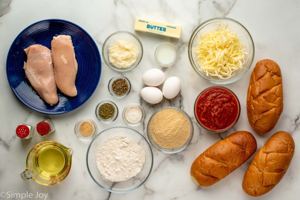 Overhead view of ingredients for Chicken Parm Sandwiches recipe on the countertop. - 4