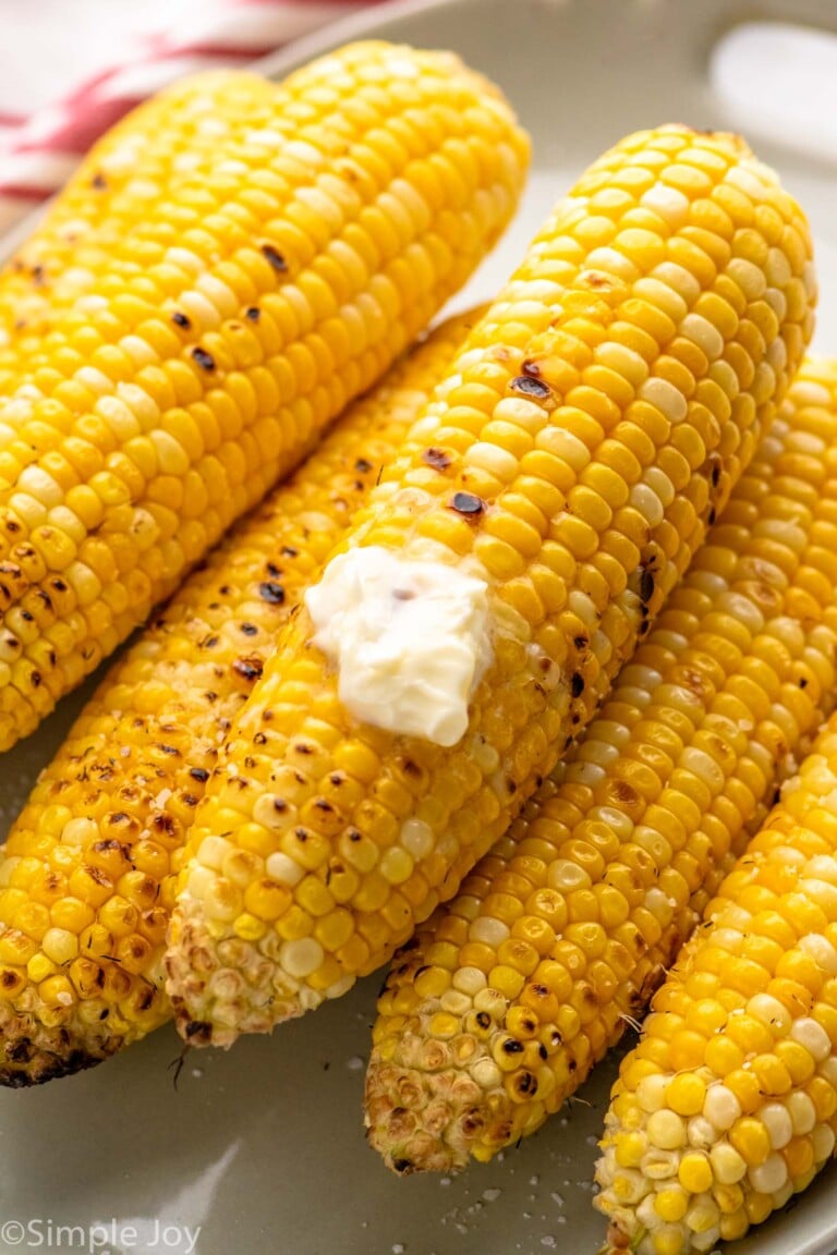 close up of grilled corn with butter melting on it