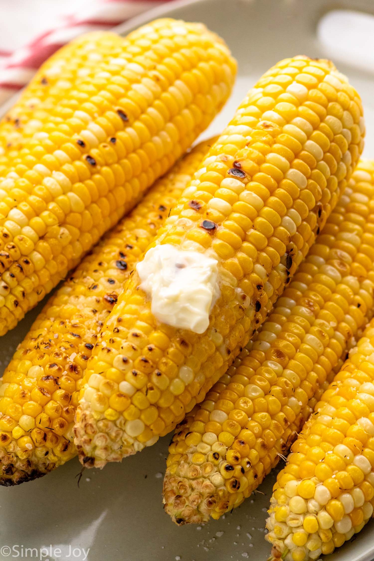 close up of grilled corn with butter melting on it