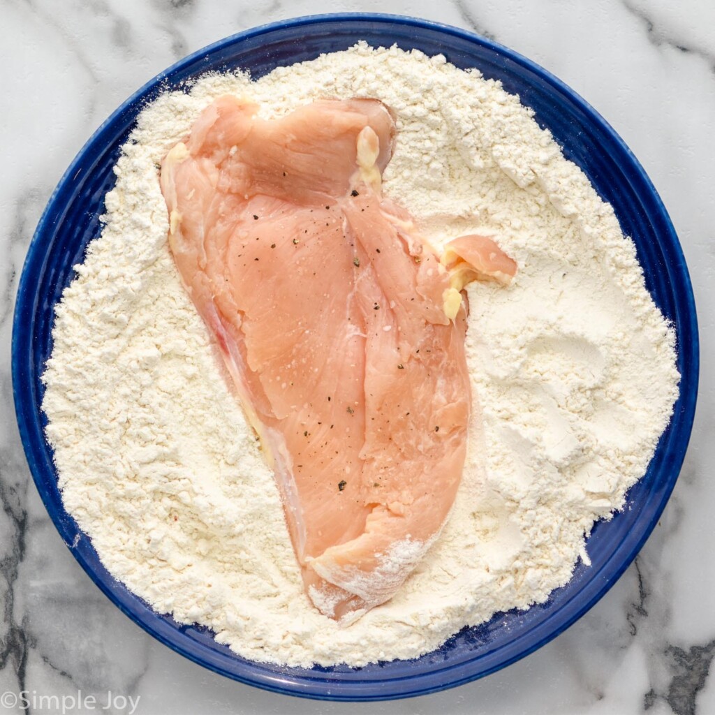 chicken breast that has been salted and peppered in flour for a chicken parmesan sandwich - 6