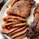 Sliced steak made with steak marinade on a plate. - 10