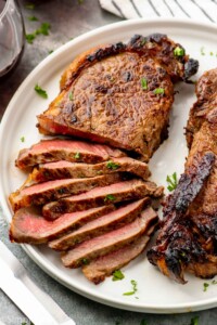 Sliced steak made with steak marinade on a plate.