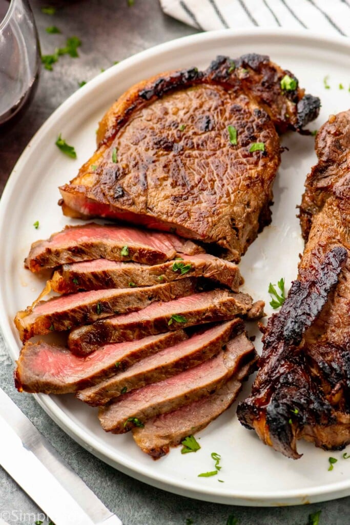 Sliced steak made with steak marinade on a plate.