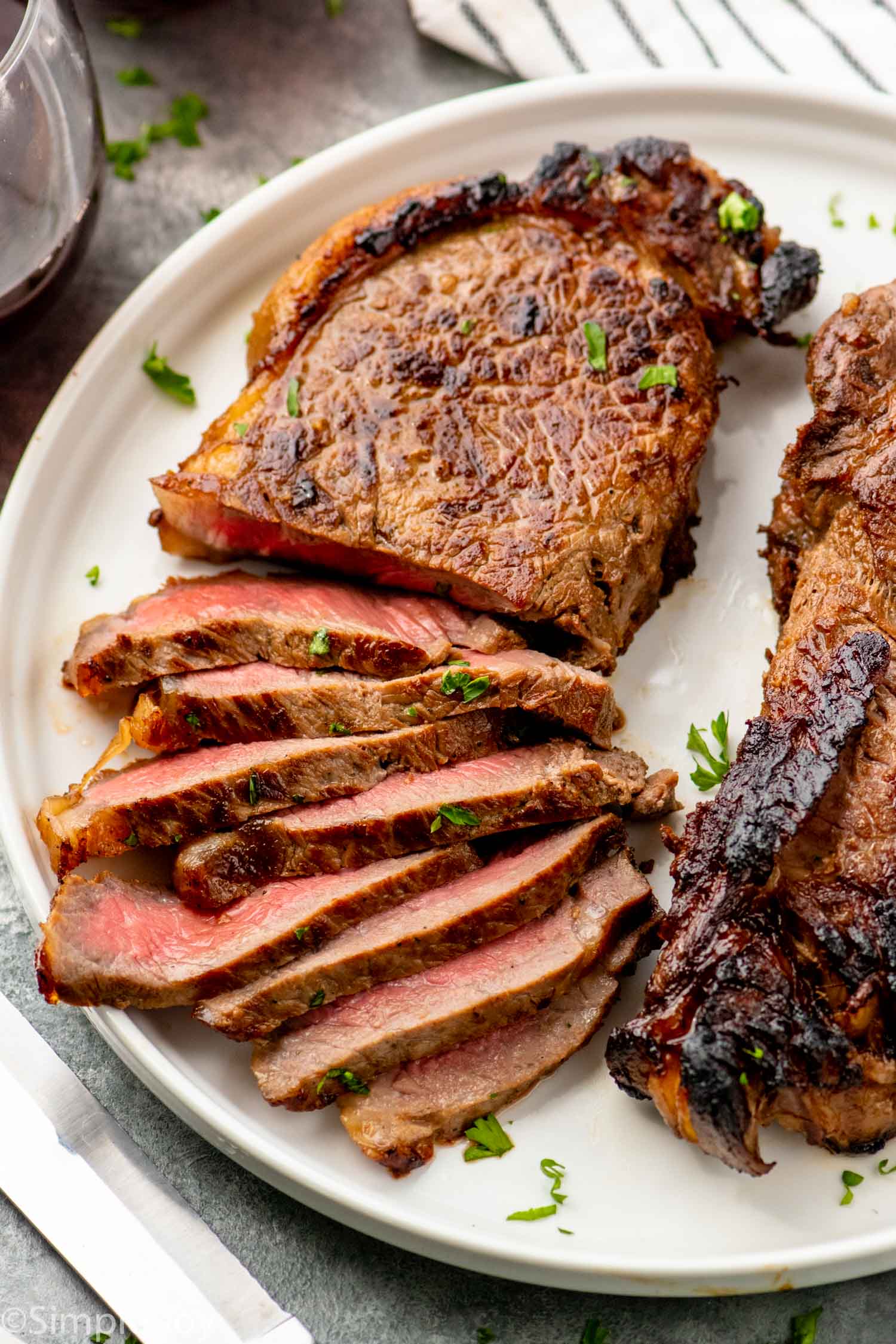 Sliced steak made with steak marinade on a plate.