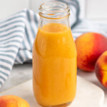 Jar of Peach syrup with peaches beside - 14