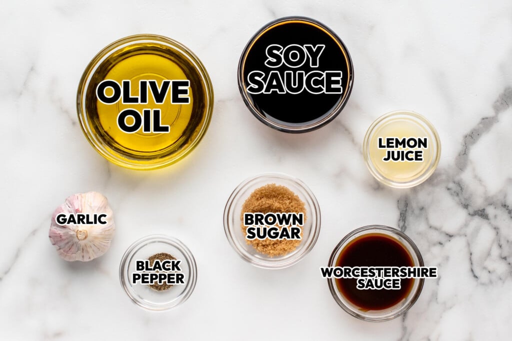 Overhead view of ingredients displayed on countertop for steak marinade recipe.