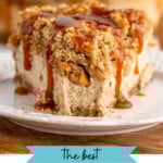 Pinterest graphic for Caramel Apple Cheesecake recipe. Image shows front view of a slice of Caramel Apple Cheesecake garnished with caramel served on a plate. Text says, "the best Caramel Apple Cheesecake simplejoy.com."