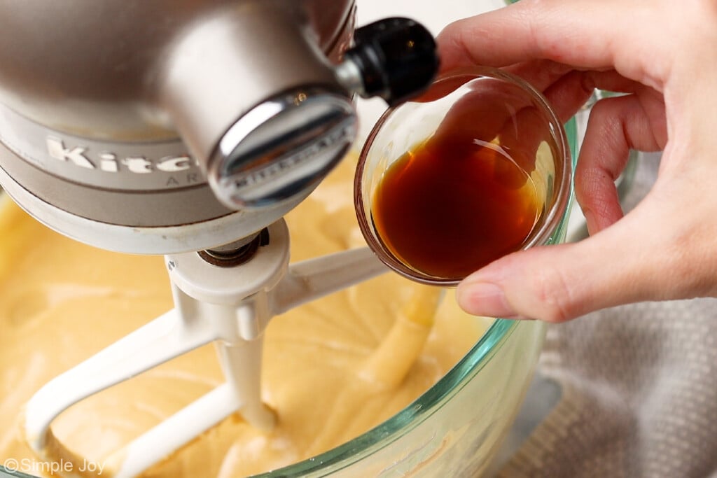a small bowl with vanilla above a stand mixer bowl
