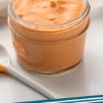 Pinterest graphic for Sriracha Mayo recipe. Image shows a jar of Sriracha Mayo with a small spoon beside. Text says, "Sriracha Mayo simplejoy.com."