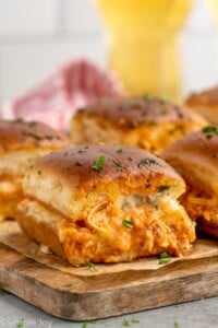 Side view of Buffalo Chicken Sliders on a serving board. - 10