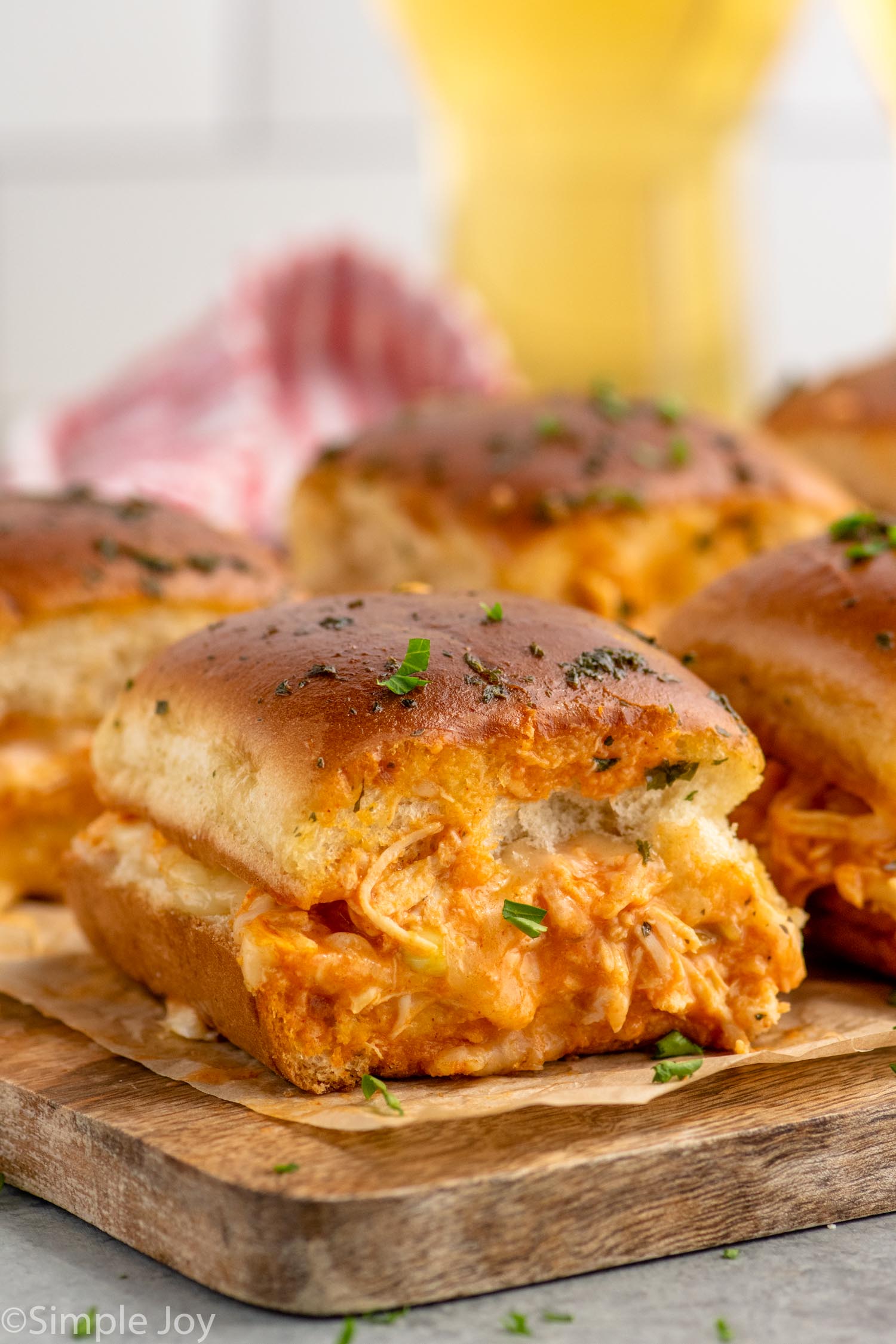 Side view of Buffalo Chicken Sliders on a serving board.