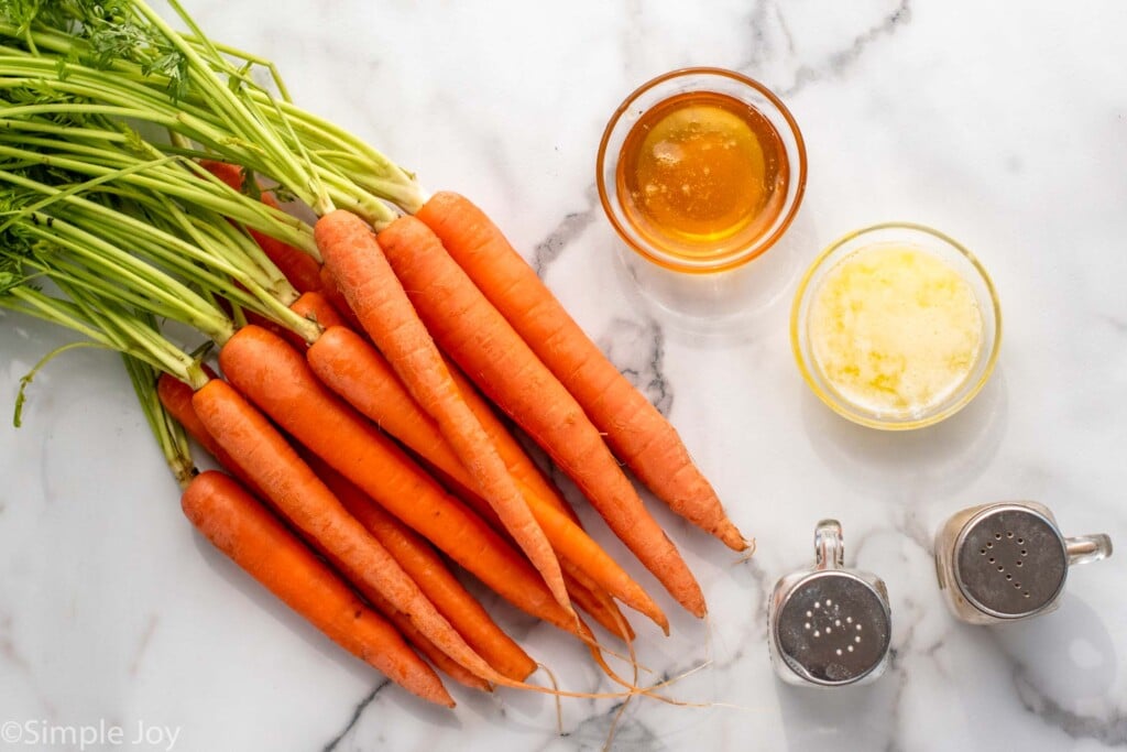Overhead view of ingredients on countertop for Honey Roasted Carrots recipe.