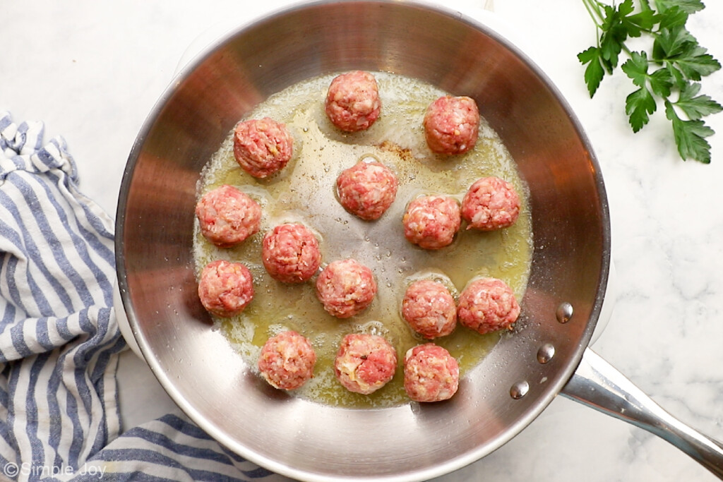 meatballs in a frying pan with butter to fry them