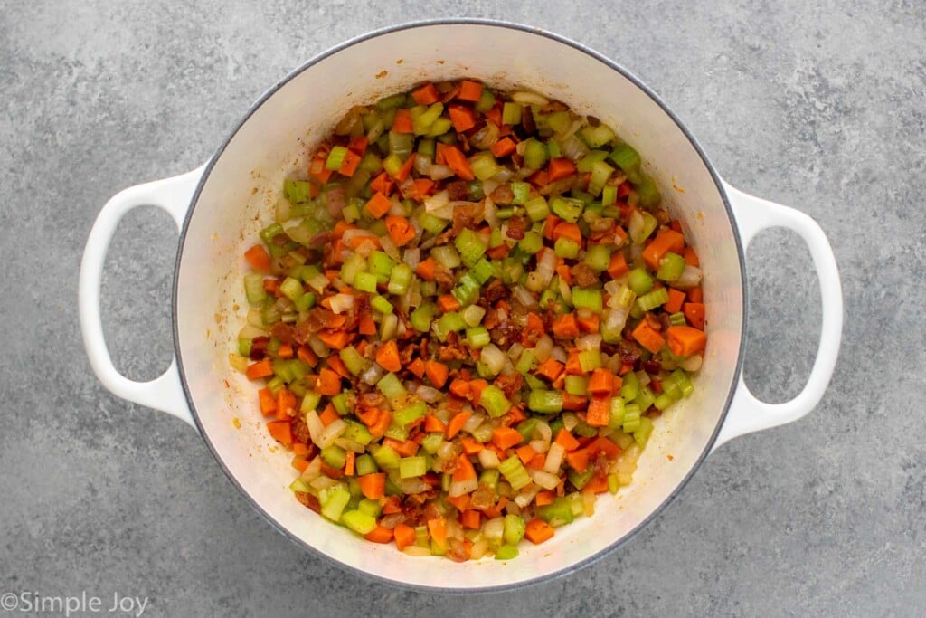 Overhead view of chopped vegetables in a pot for Manhattan Clam Chowder recipe. - 7