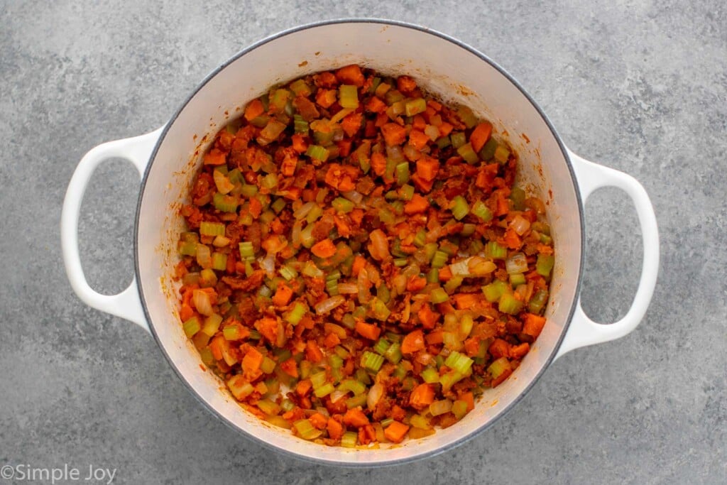 Overhead view of chopped vegetables in a pot for Manhattan Clam Chowder recipe - 8