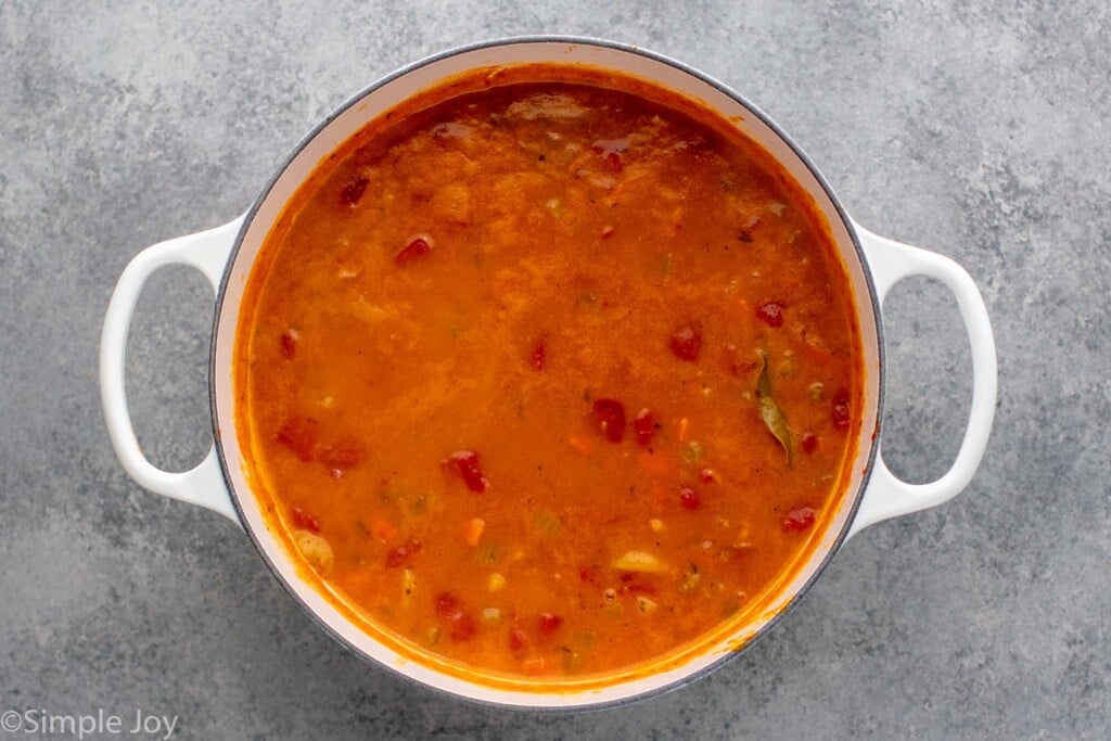 Overhead view of ingredients in a pot for Manhattan Clam Chowder recipe - 9