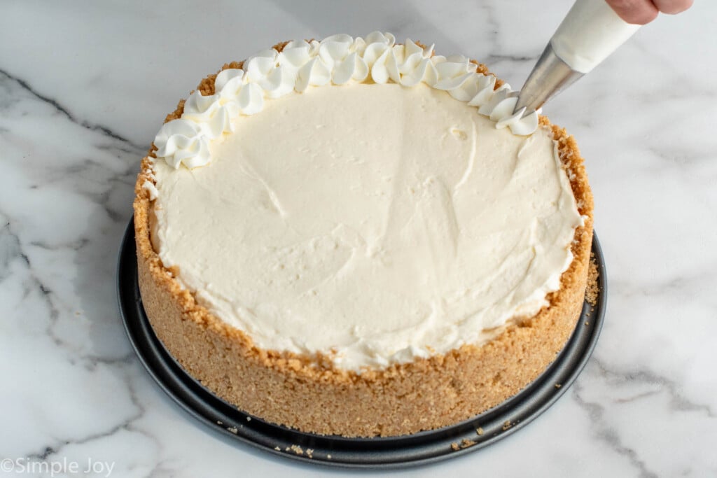 Piping set adding whipped cream to border of No Bake Cheesecake - 12