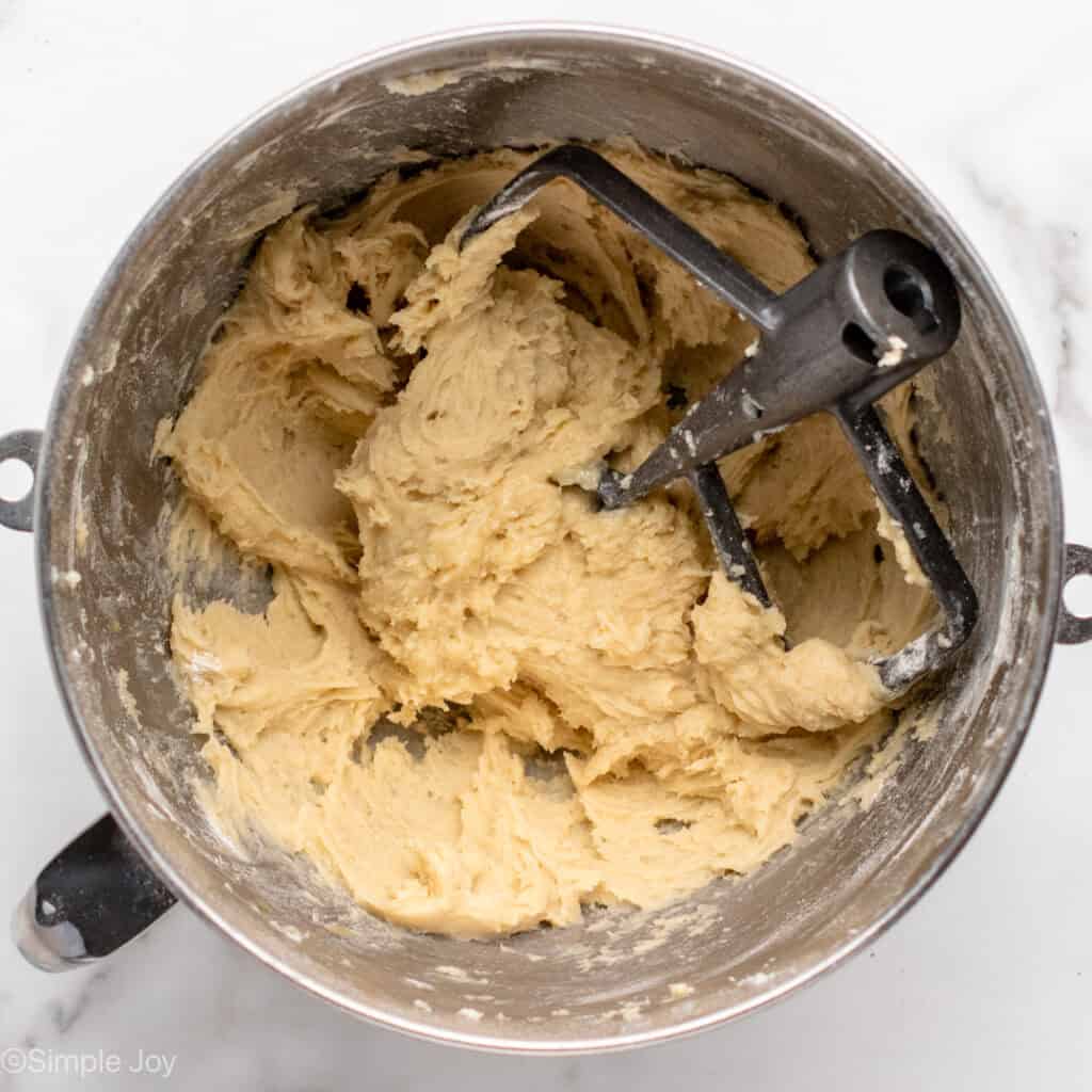 overhead of dough for peach cobbler in a mixing bowl