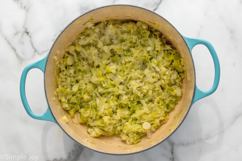 Overhead view of a pot of cooked leeks for potato leek soup recipe. - 5